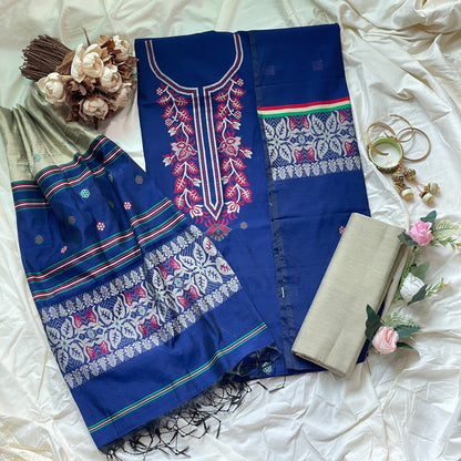 Blue embroidered fabric with floral patterns on a white surface with decorative elements.